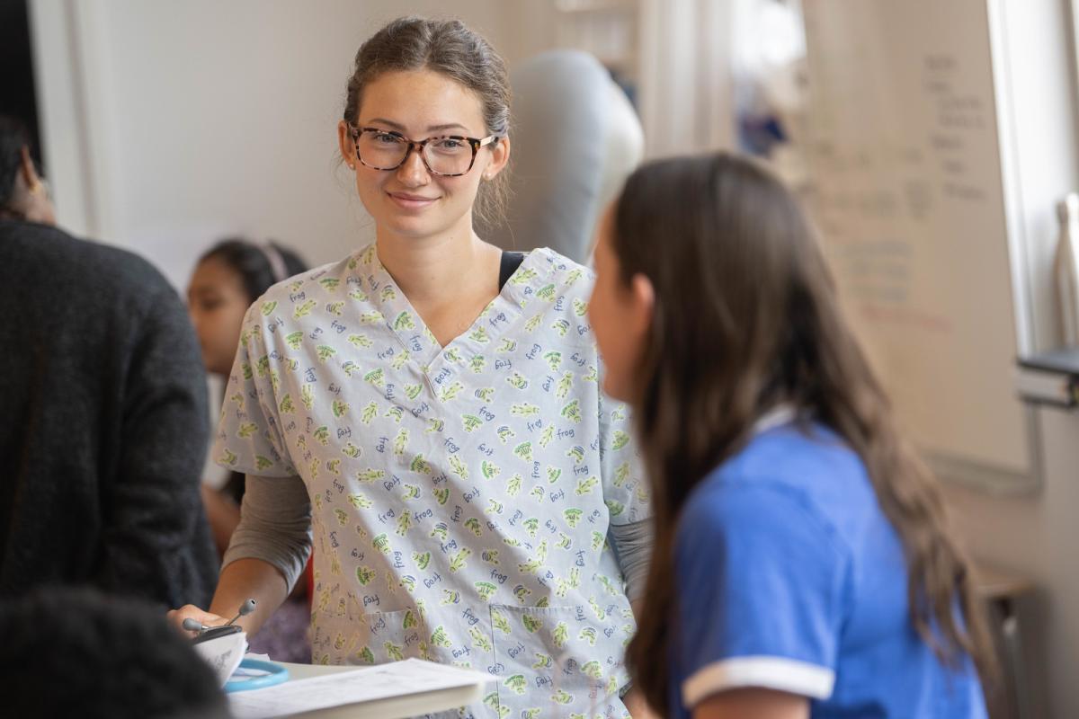 Student smiling while engaged in a hands-on activity in the simulation lab.