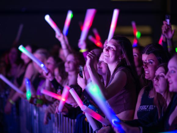 Spring Weekend Concert Group of Students Smiling with Glow Sticks