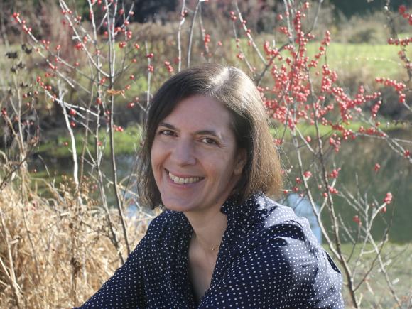 Faculty member Rebecca Olander smiling outdoors.