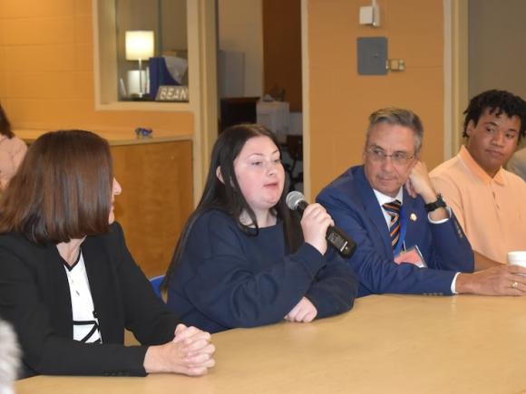 Elizabeth Bennett, left, an association commissioner in the state's Department of Elementary and Secondary Education, and Westfield Mayor Michael McCabe listen as high school seniors Aubrey Exware, second from left, and Matthew Robinson speak about the early college program in Westfield. (AMY PORTER / THE WESTFIELD NEWS).