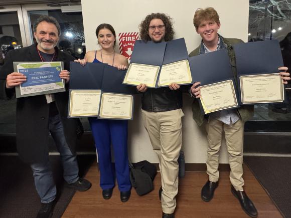 Faculty member and students holding awards at the Region 1 Kennedy Center American College Theatre Festival (KCACTF).