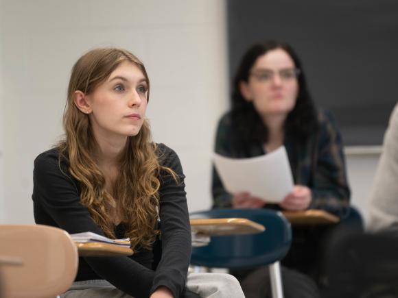 Two students listening intently during a classroom lecture.