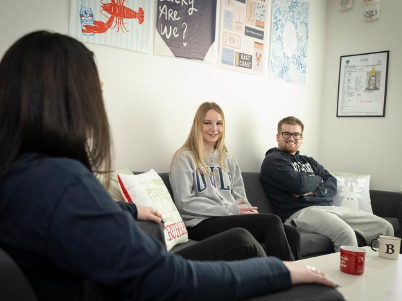 student chatting in dorm room. 