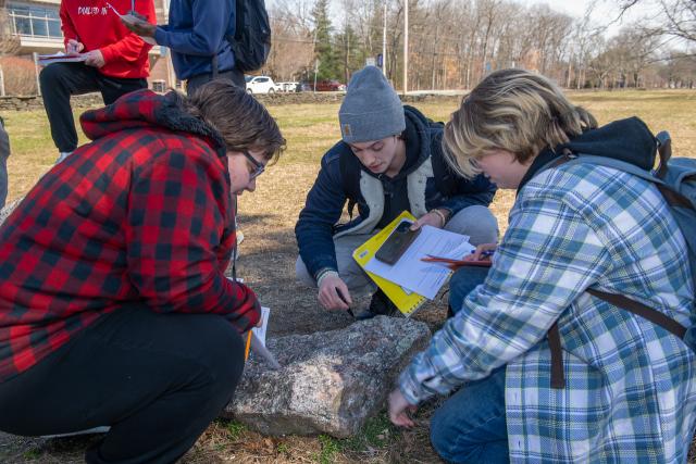 Students working together in a group during an outside lab.