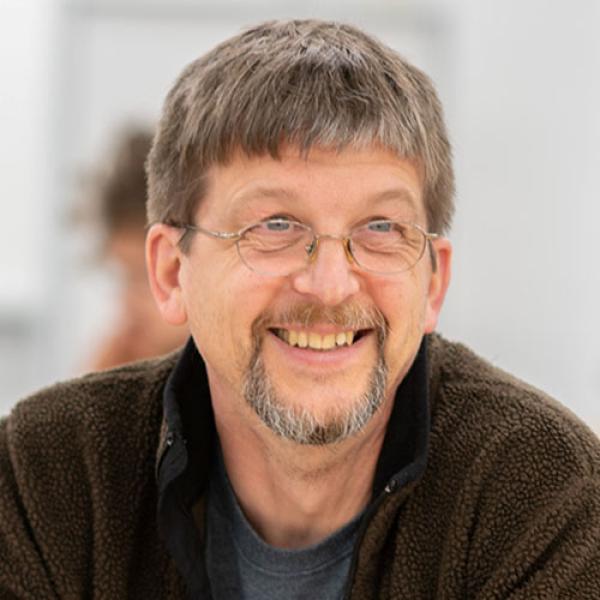 Dr. Karsten Theis, Acting Chair of the Chemical and Physical Sciences Department at Westfield State University, smiles while in a classroom.