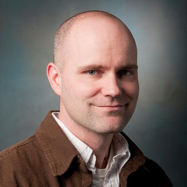  David Christensen, Chair of the Biology Department at Westfield State University, smiles while posing for a professional photo.